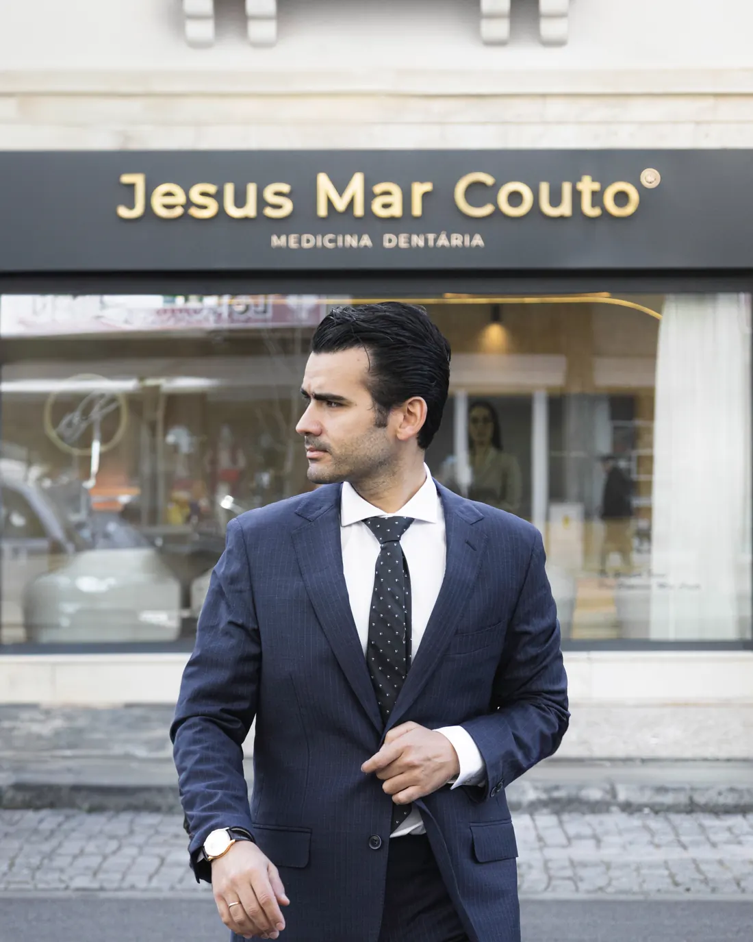 Dr. Gonçalo Jesus at the entrance to the Jesus Mar Couto — Medicina Dentária clinic, on Avenida Dr. Lourenço Peixinho, in Aveiro